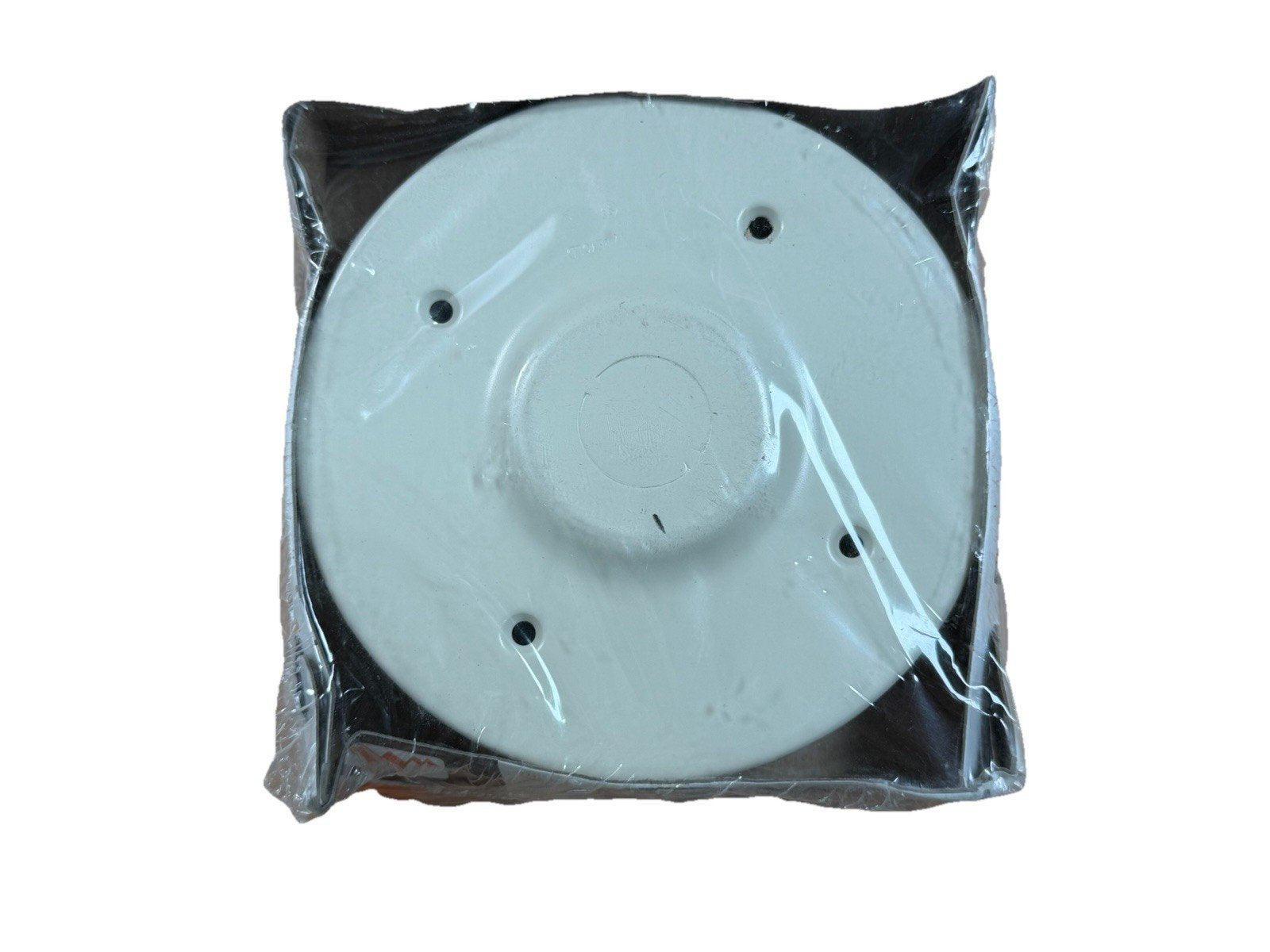 White fire alarm base plate in plastic wrap, ready for installation