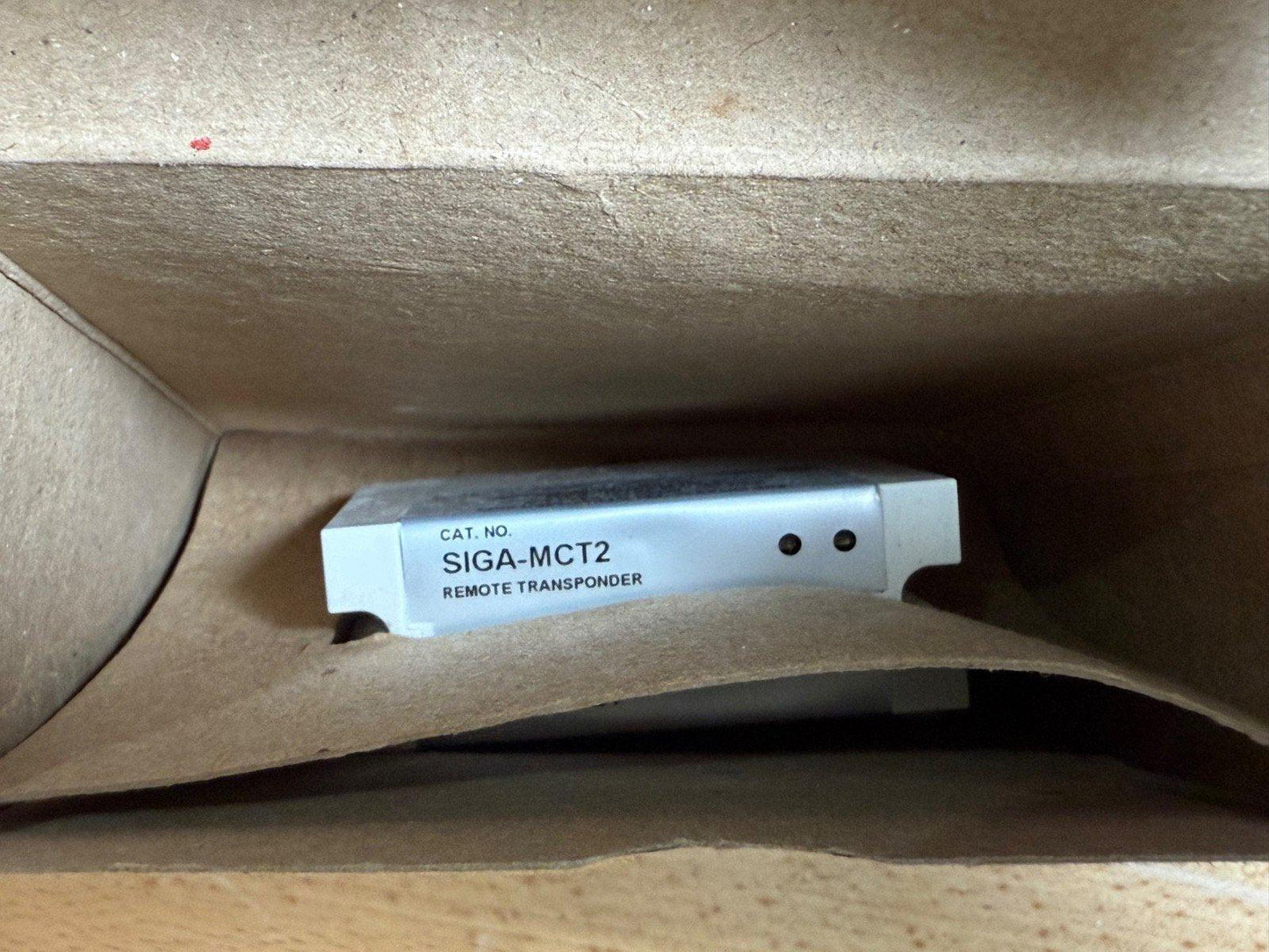 SIGA-MCT2 remote transponder fire alarm component in cardboard packaging