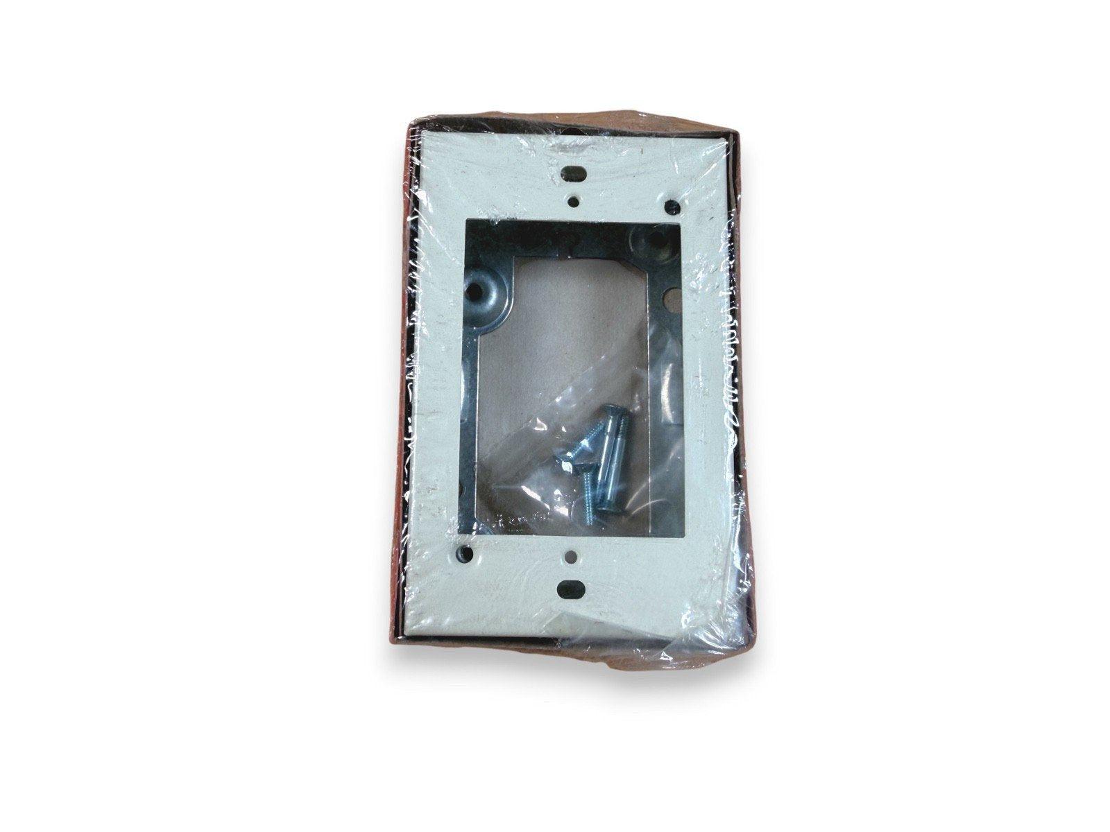 Fire alarm mounting bracket with screws, packaged for installation