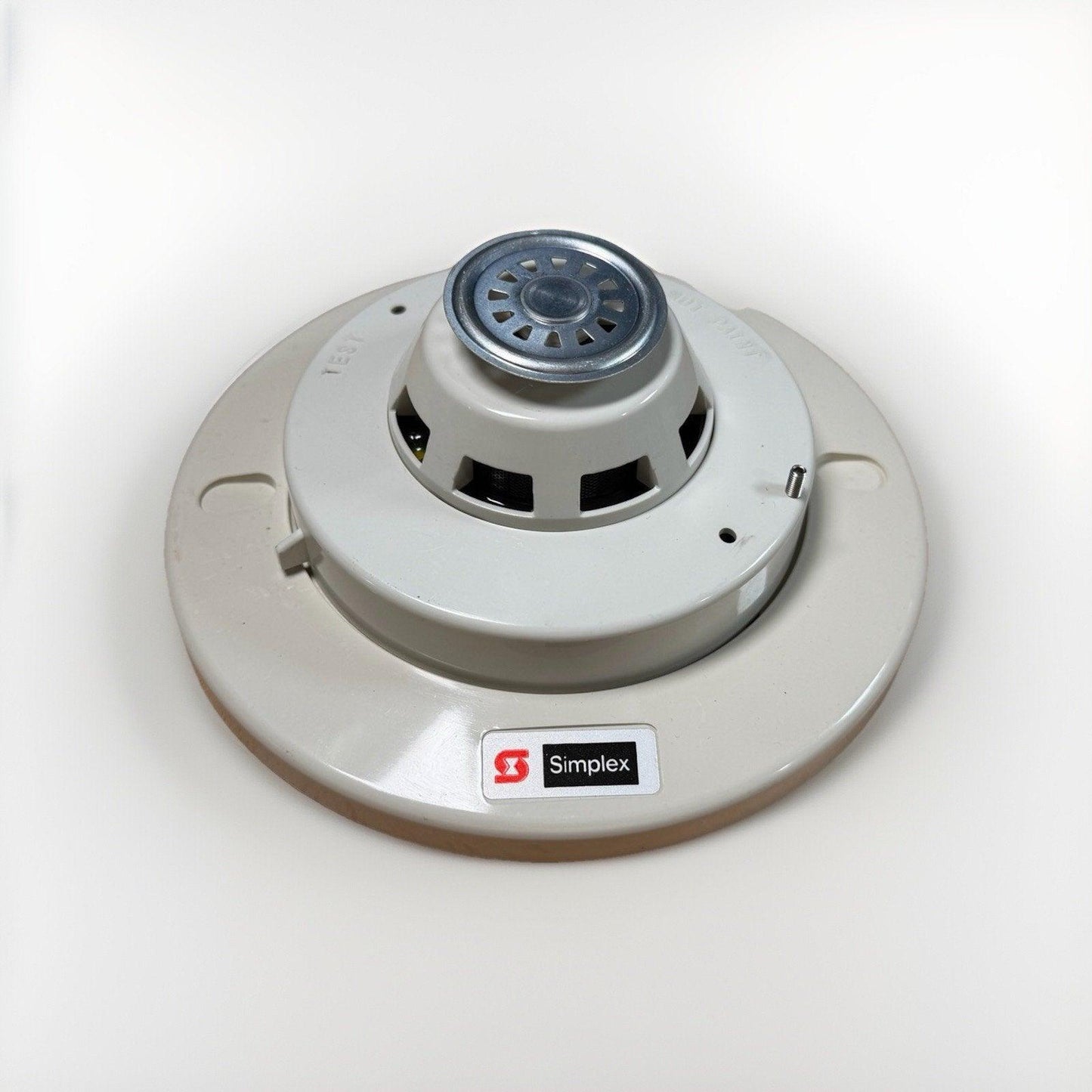 Simplex fire alarm detector with test button, white ceiling mount smoke sensor