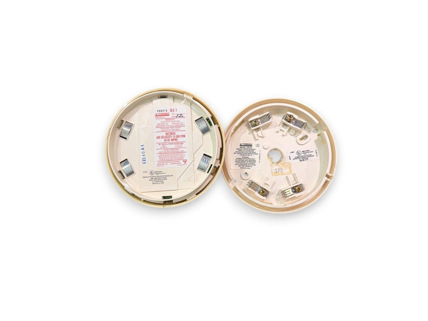 Used fire alarm smoke detector heads with wiring terminals and labels, for commercial fire safety systems