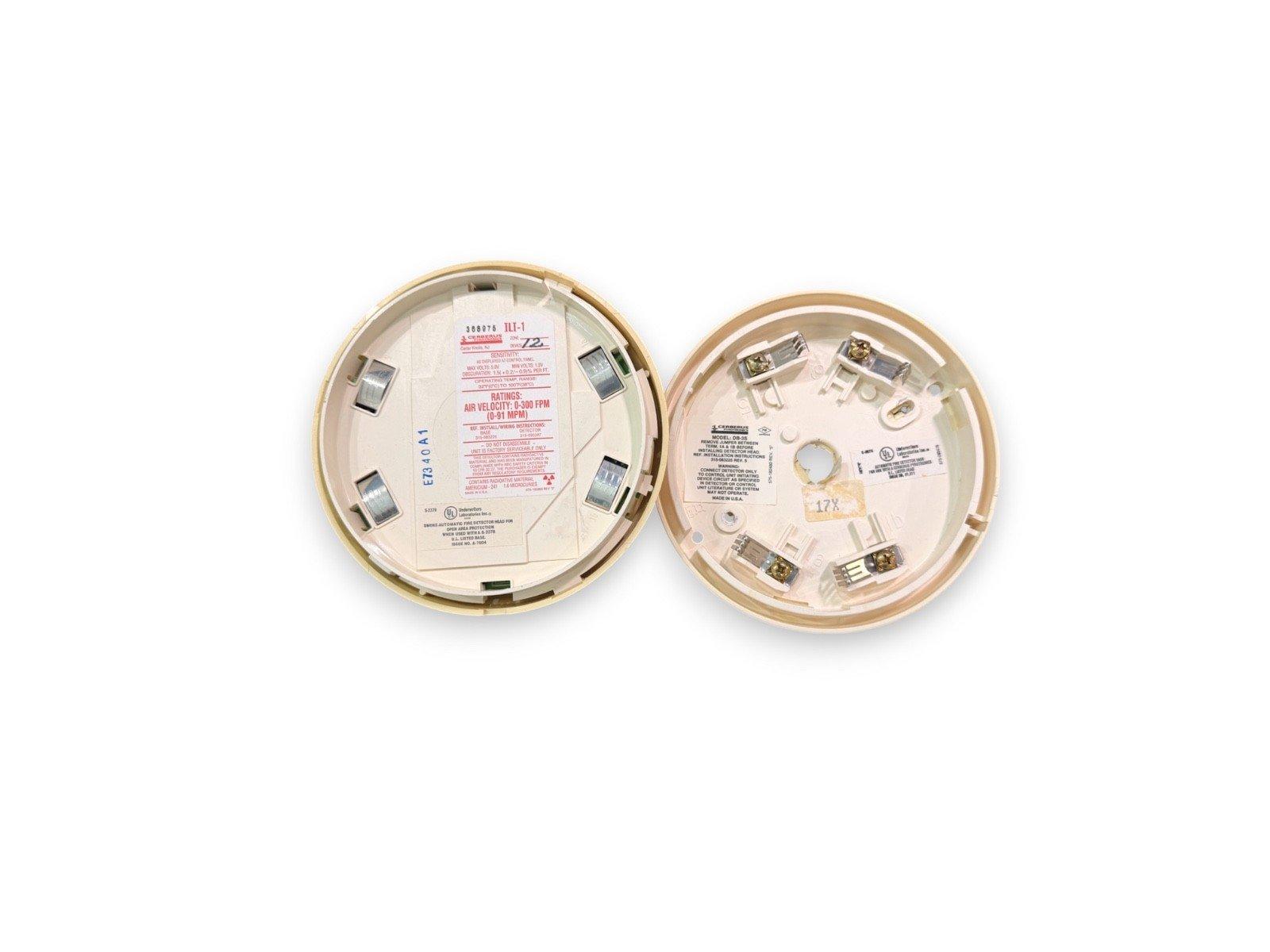 Used fire alarm smoke detector heads with wiring terminals and labels, for commercial fire safety systems