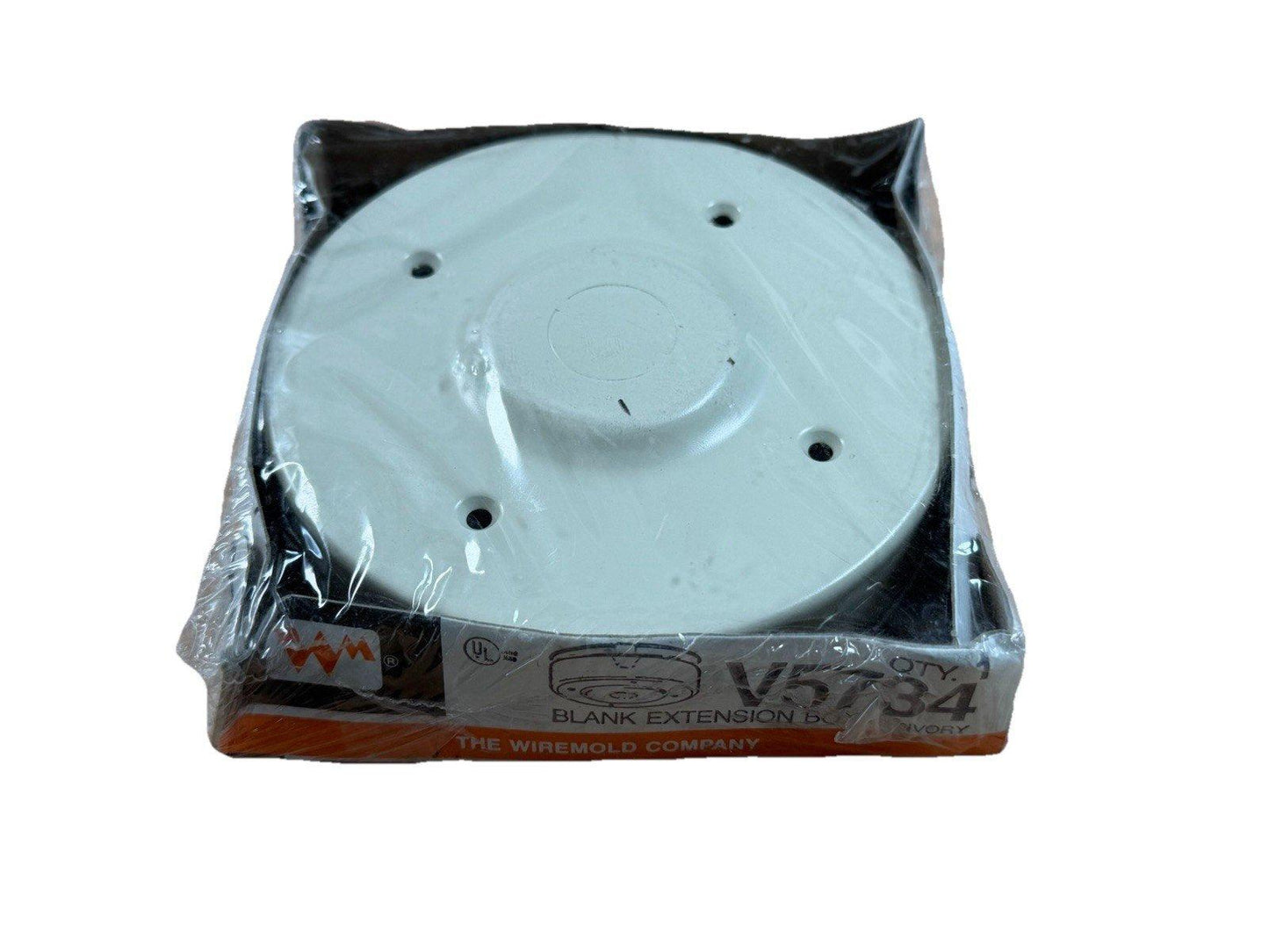 White fire alarm blank extension base V5734 in packaging, compatible with smoke detectors and fire safety systems