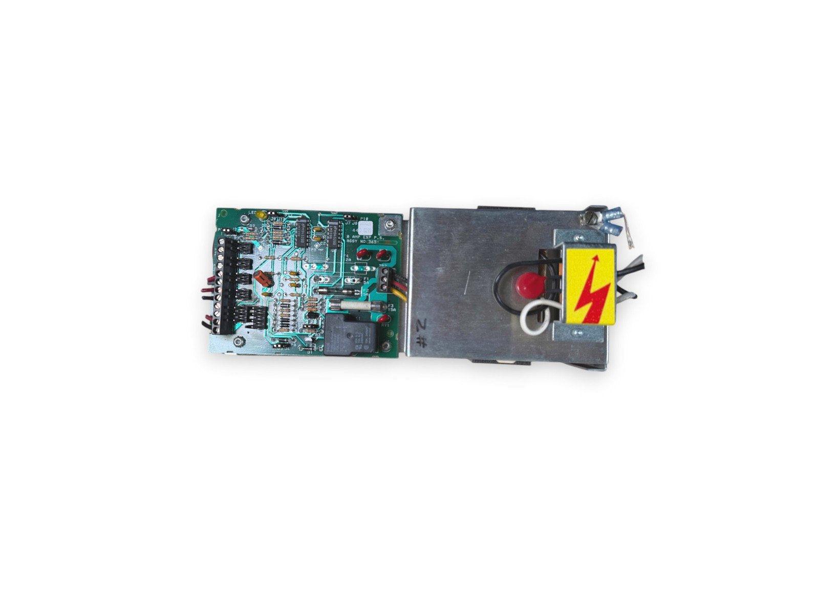 Fire alarm control panel circuit board with power supply and warning label