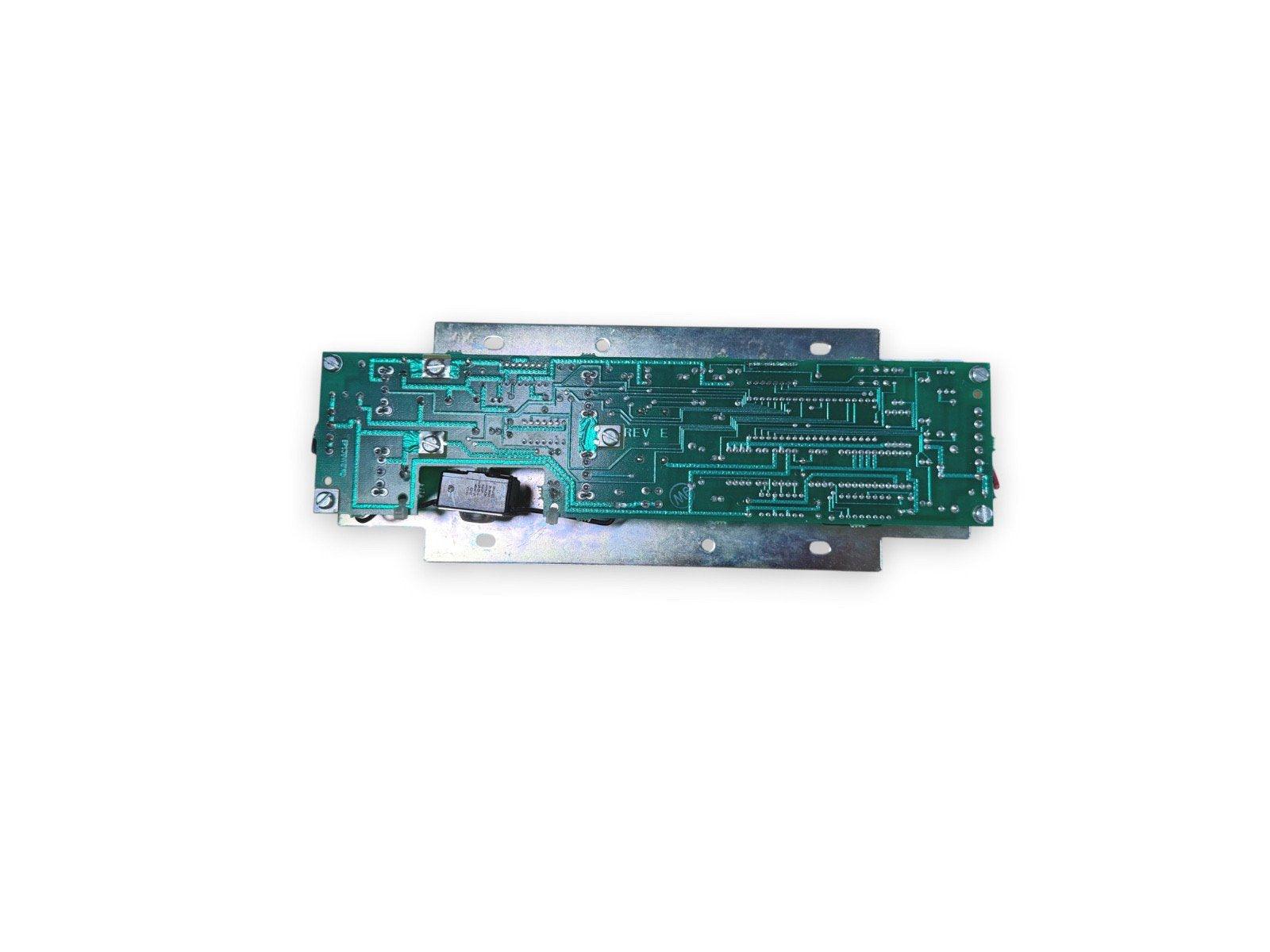 Fire alarm control panel circuit board with green PCB and metal mounting bracket