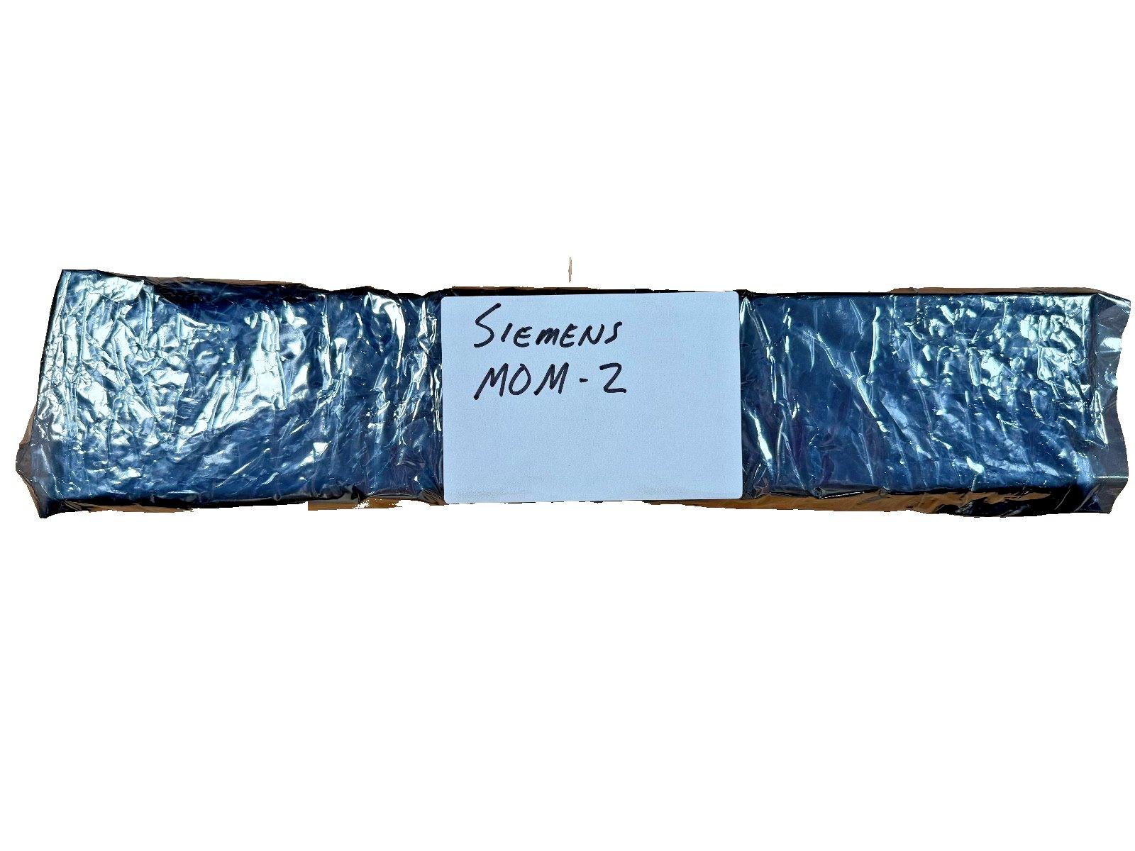 Siemens MOM-2 fire alarm module in protective blue wrap, labeled for identification