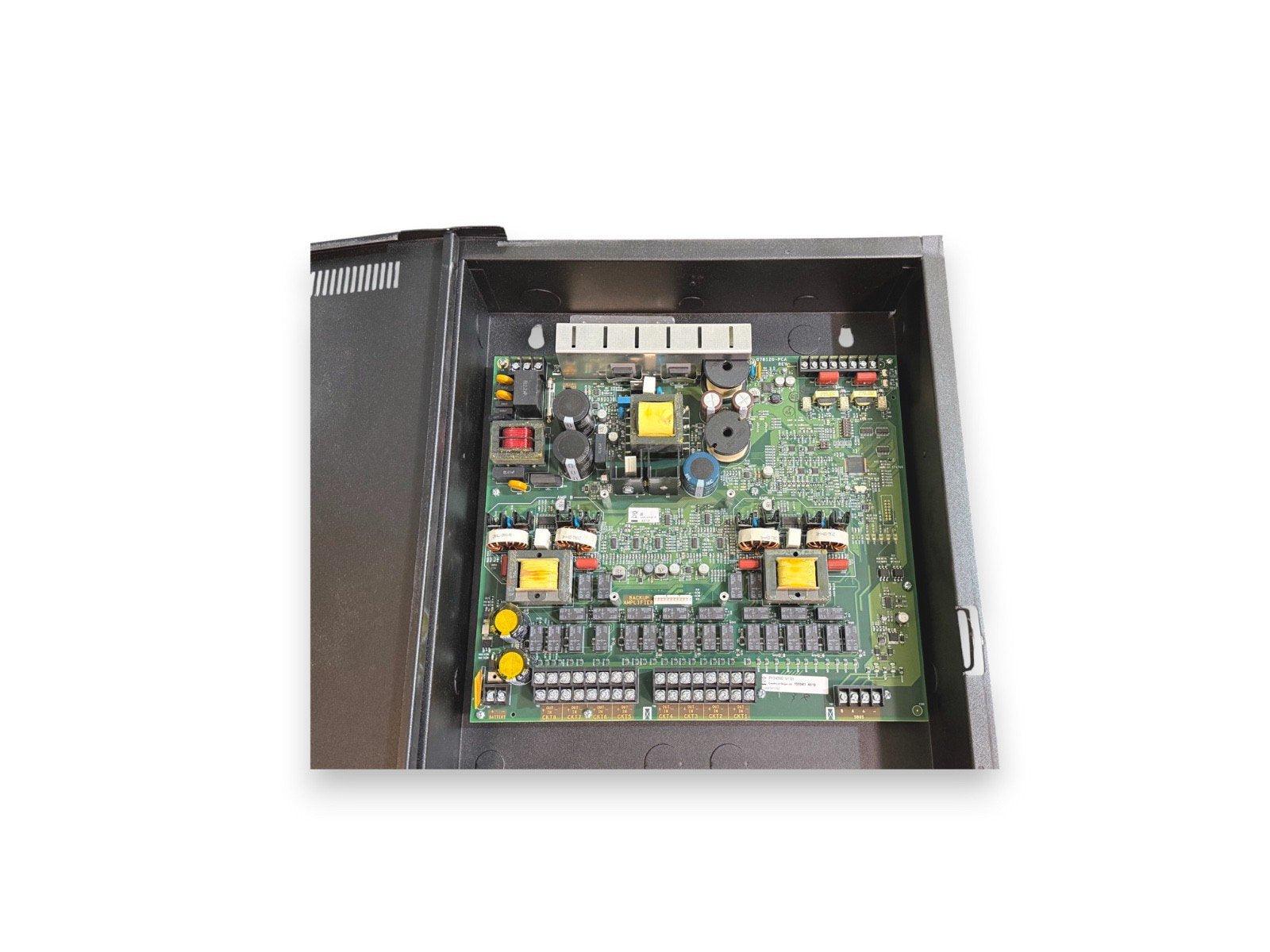 Fire alarm control panel circuit board with capacitors and connectors inside metal enclosure