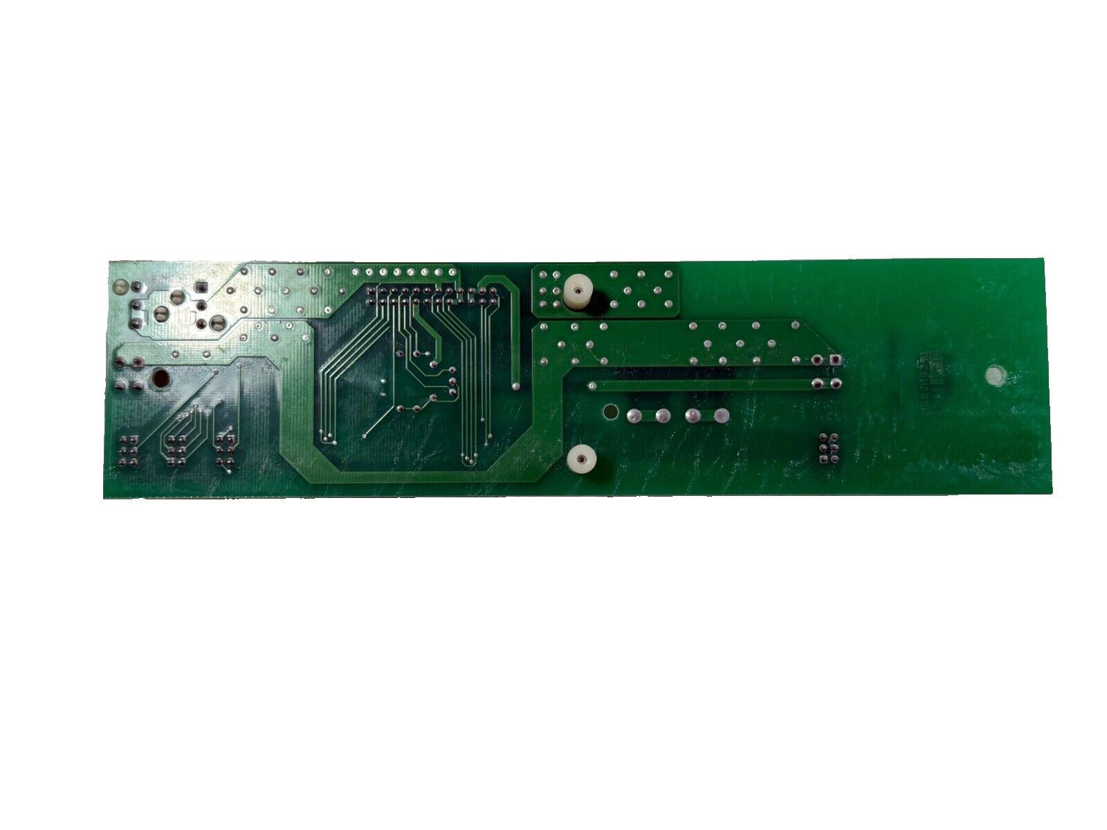 Green fire alarm control panel circuit board with solder points and traces
