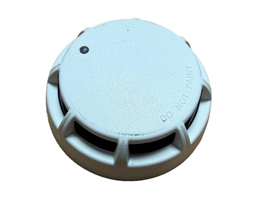 White smoke detector with 'DO NOT PAINT' label, fire alarm safety device