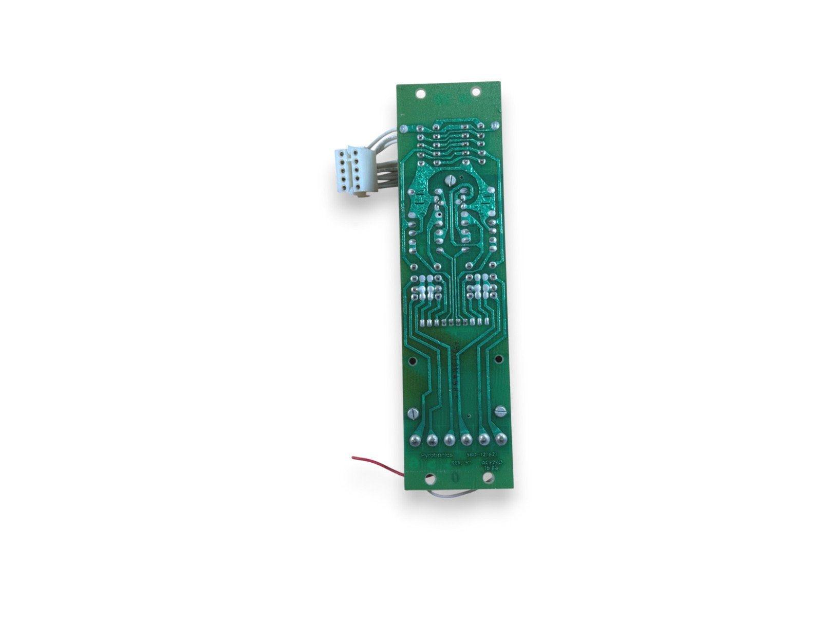 Green fire alarm control panel circuit board with connectors and wiring