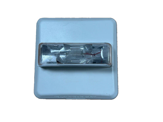 Fire alarm strobe light with clear lens and warning text, used for emergency signaling