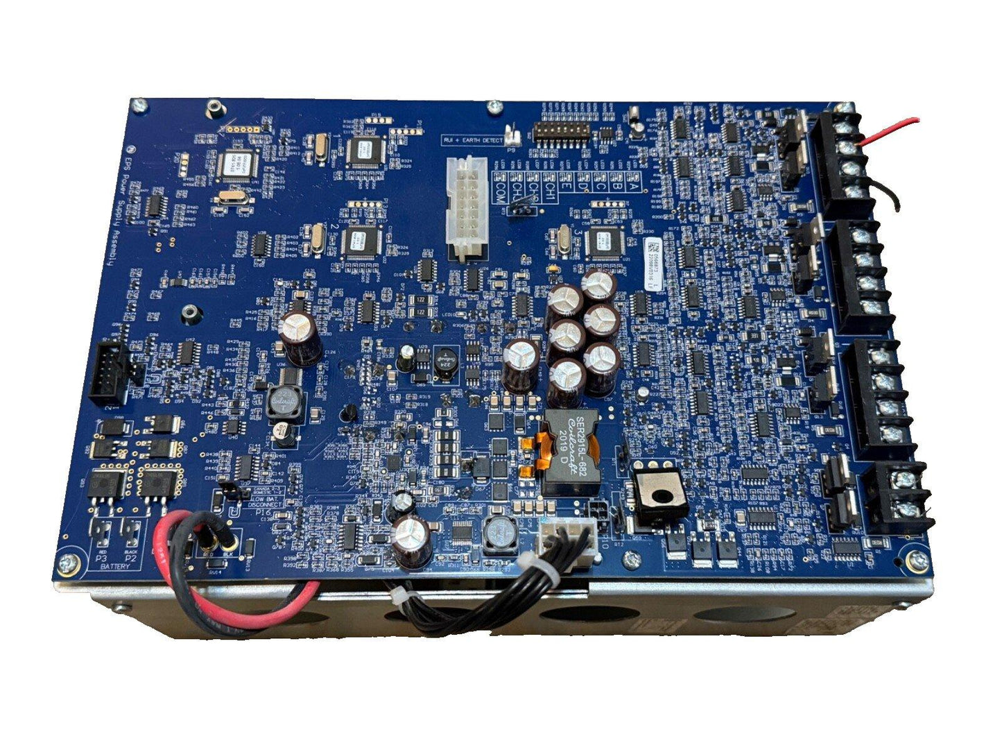 Blue fire alarm control panel circuit board with connectors and capacitors for commercial security systems