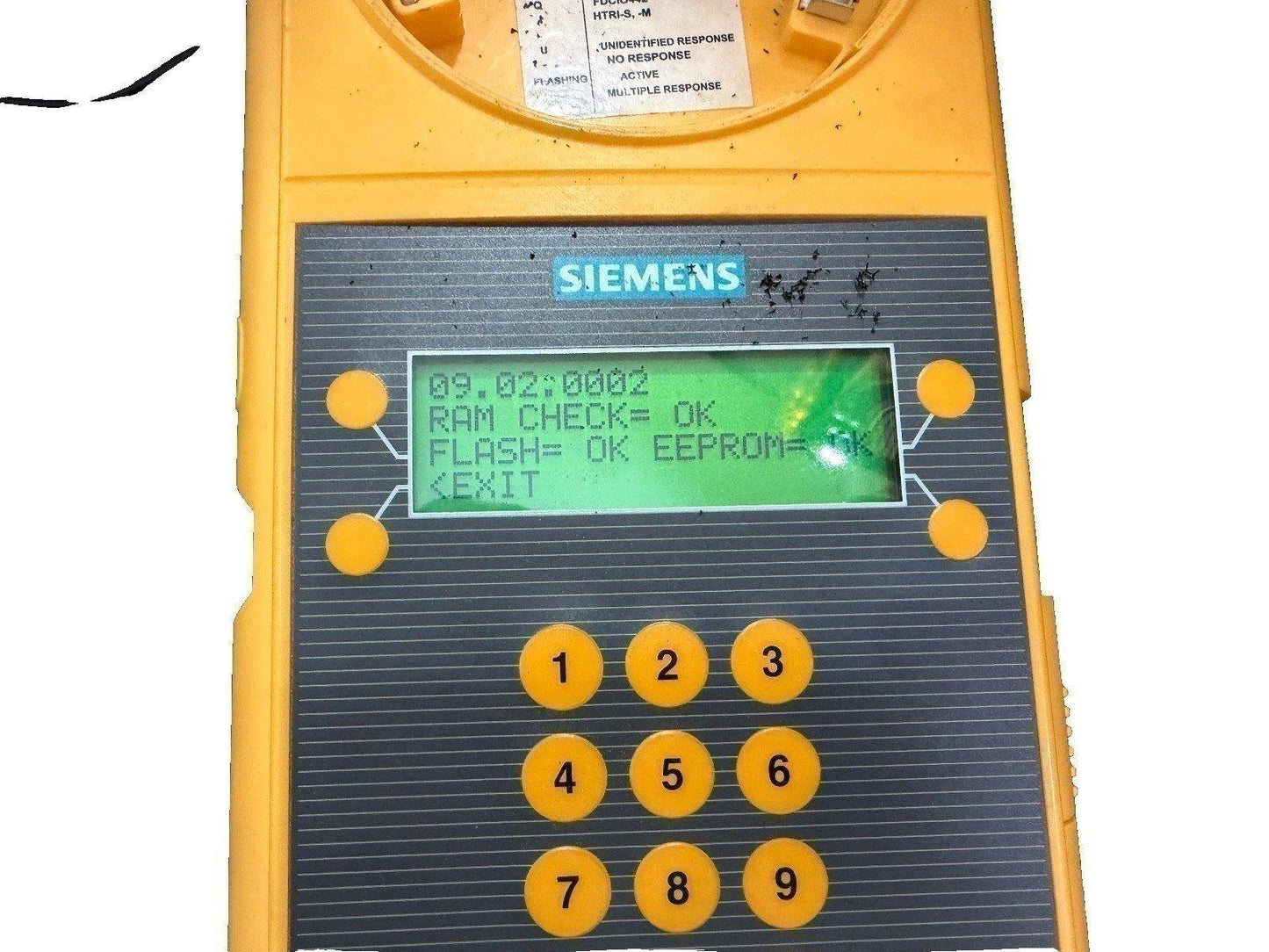 Siemens fire alarm control panel with keypad and LCD display showing system diagnostics