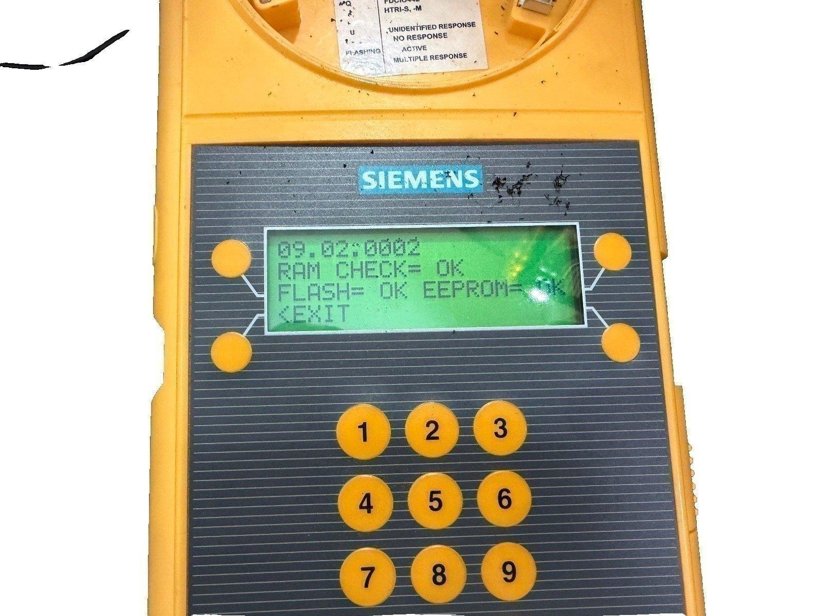 Siemens fire alarm control panel with keypad and LCD display showing system diagnostics