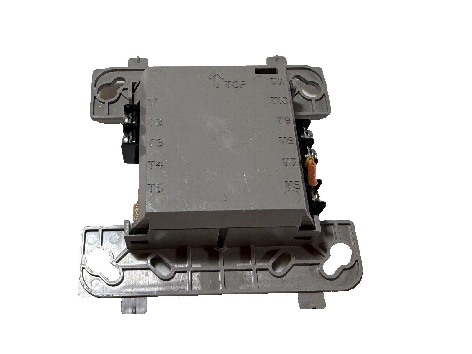 Fire alarm control module with terminal labels T1-T11, gray plastic housing, wiring connectors visible
