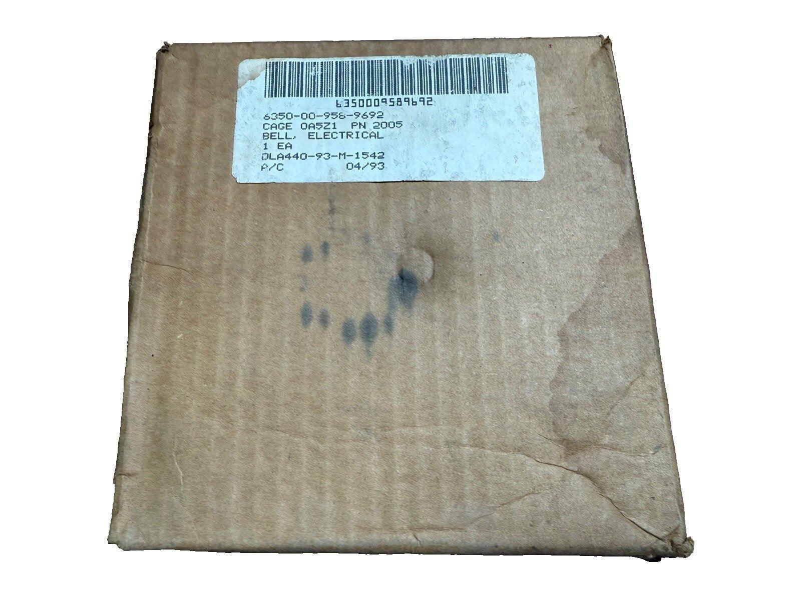 Used electrical fire alarm bell in original box, labeled with part number and CAGE code for fire safety systems