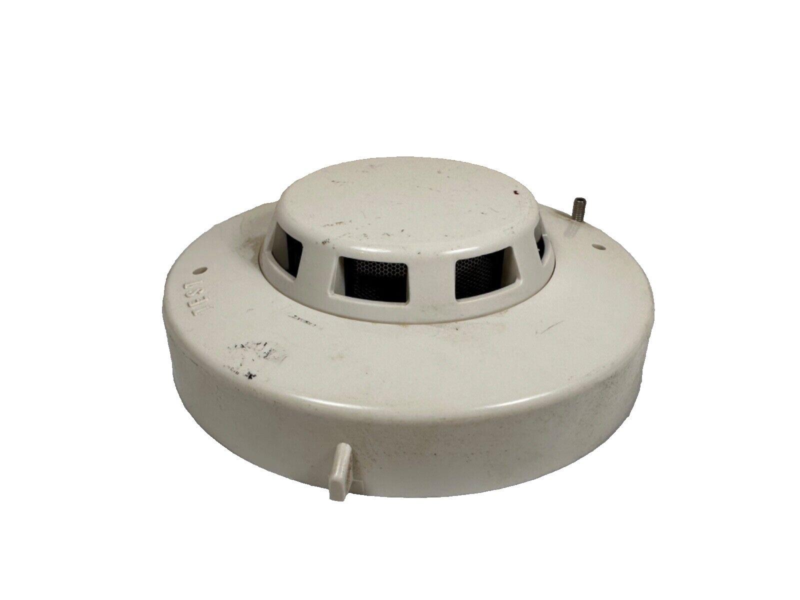 Used white smoke detector with test button for fire alarm systems