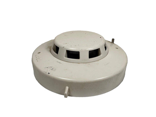Used white smoke detector with test button for fire alarm systems
