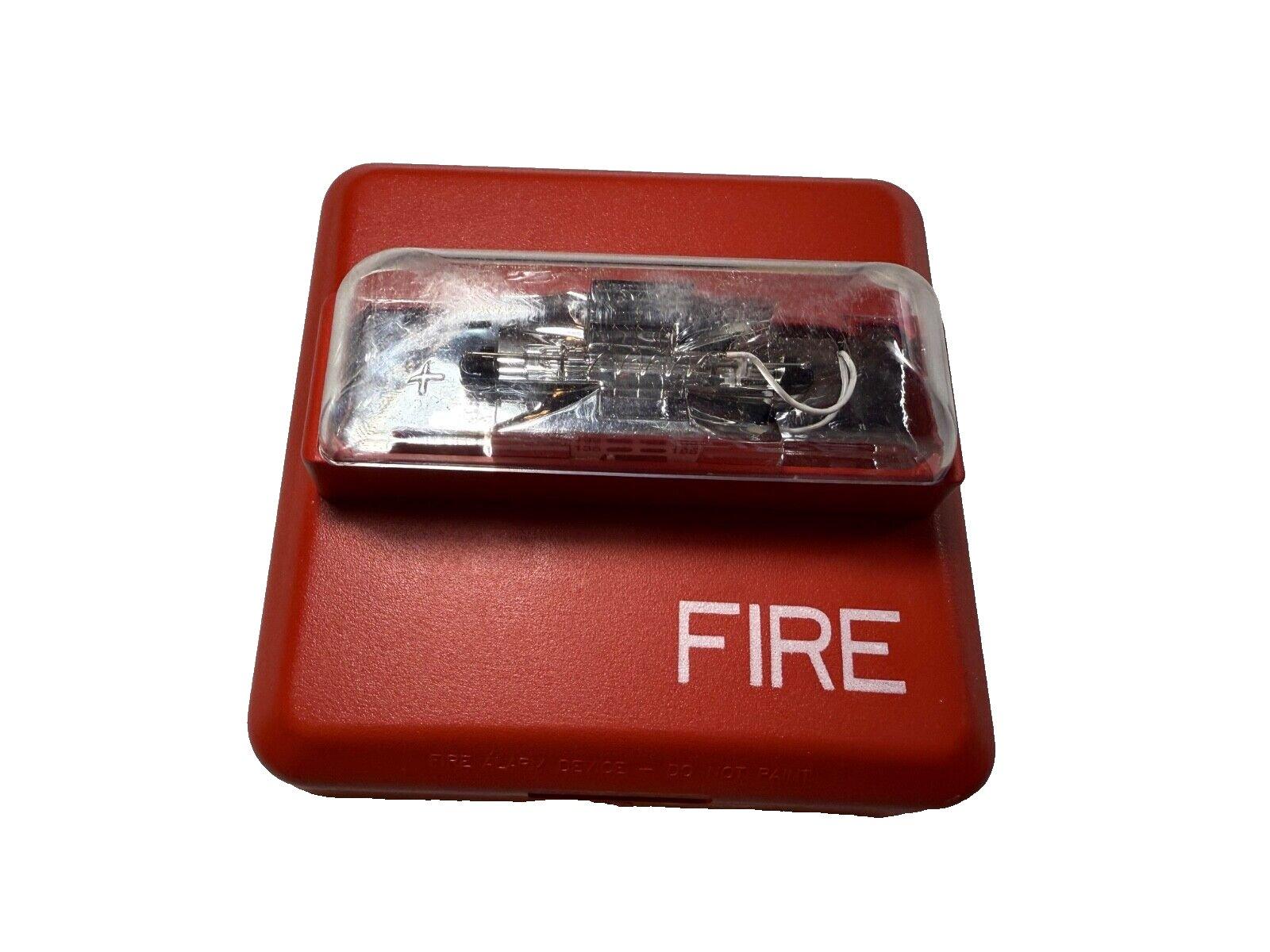 Red fire alarm pull station with clear cover and FIRE label, used fire alarm equipment