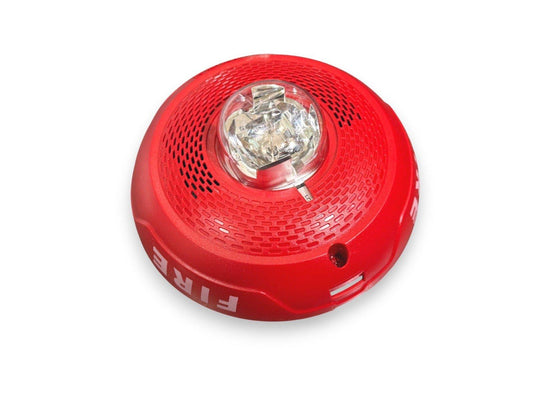 Red fire alarm strobe light with clear lens and perforated housing for emergency warning systems