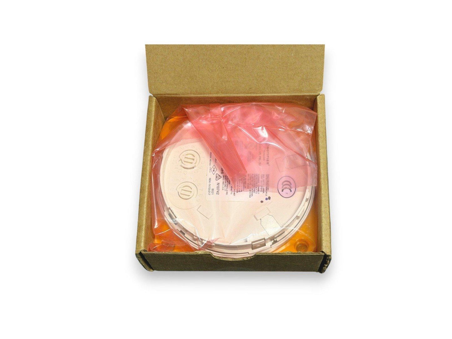 New fire alarm detector in box, wrapped in plastic, ready for installation