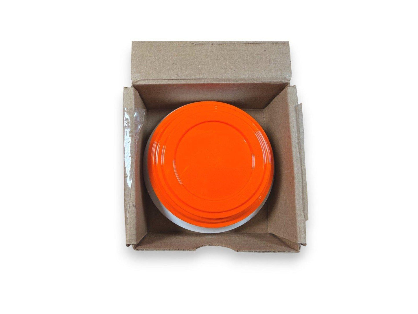 Bright orange fire alarm pull station cover in cardboard box, new fire safety equipment