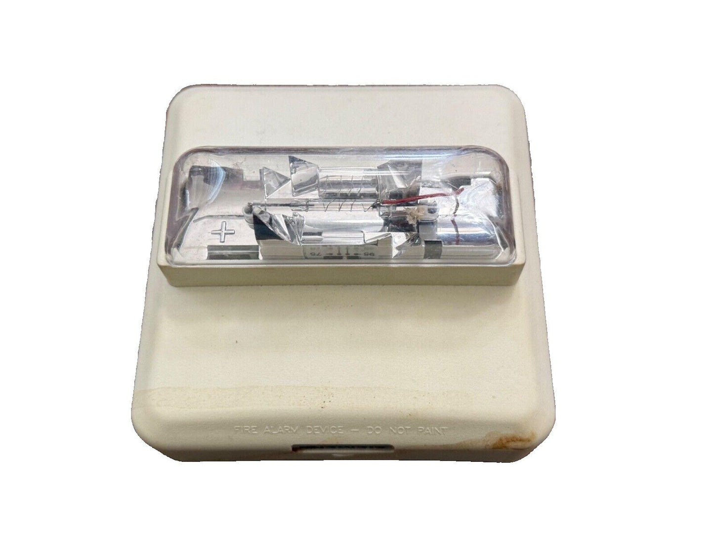 Used fire alarm strobe light with clear lens and internal components visible, labeled 'FIRE ALARM DEVICE'