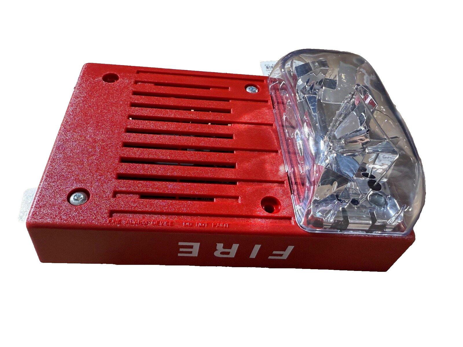 Red fire alarm horn strobe with clear lens, labeled FIRE for emergency warning systems