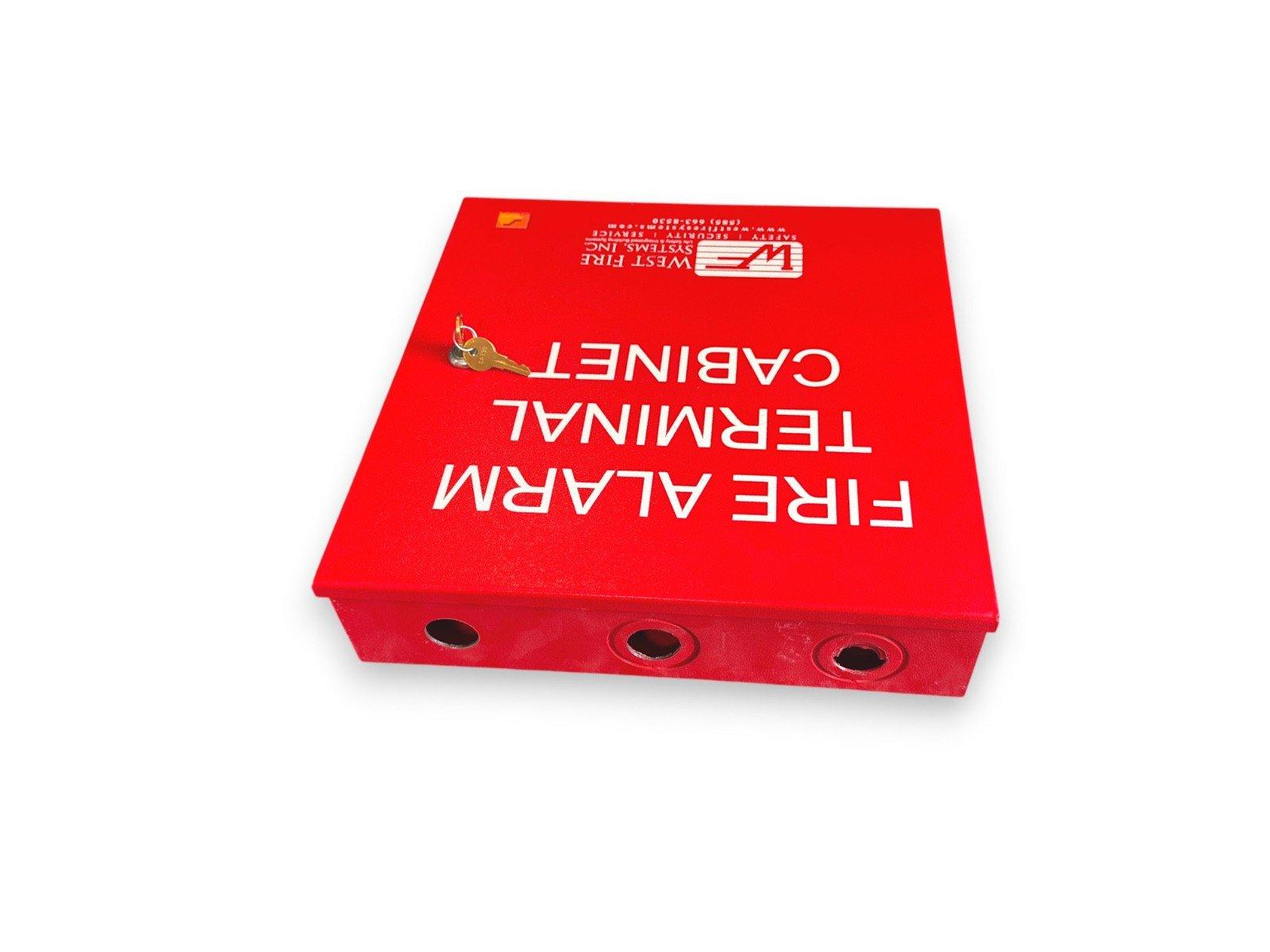 Red fire alarm terminal cabinet with key, labeled for safety systems and emergency access.
