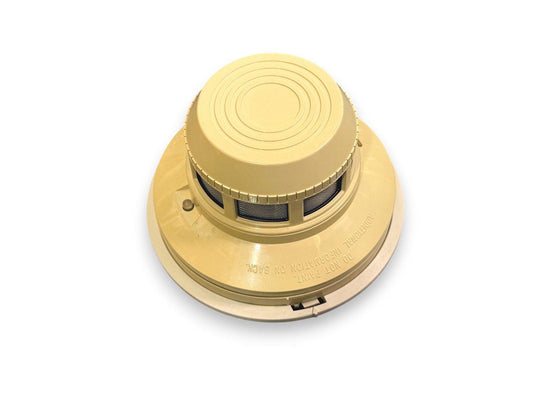 Beige smoke detector with mesh vents and mounting base for fire alarm systems