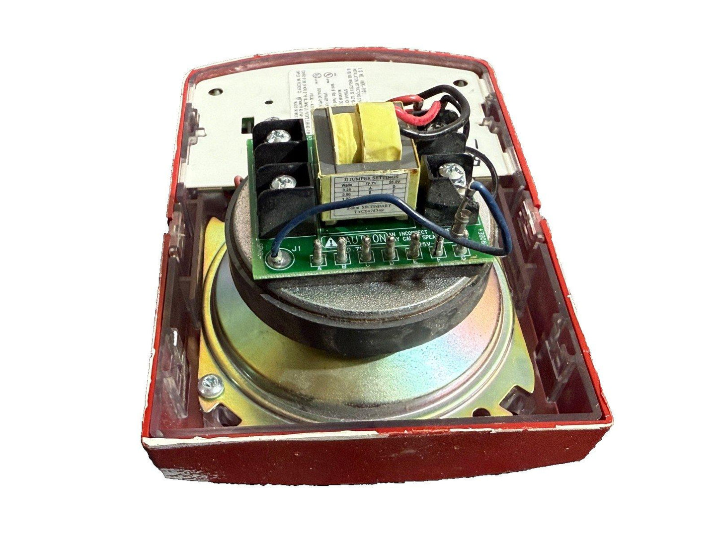 Used fire alarm horn with exposed circuit board, transformer, and wiring in red housing