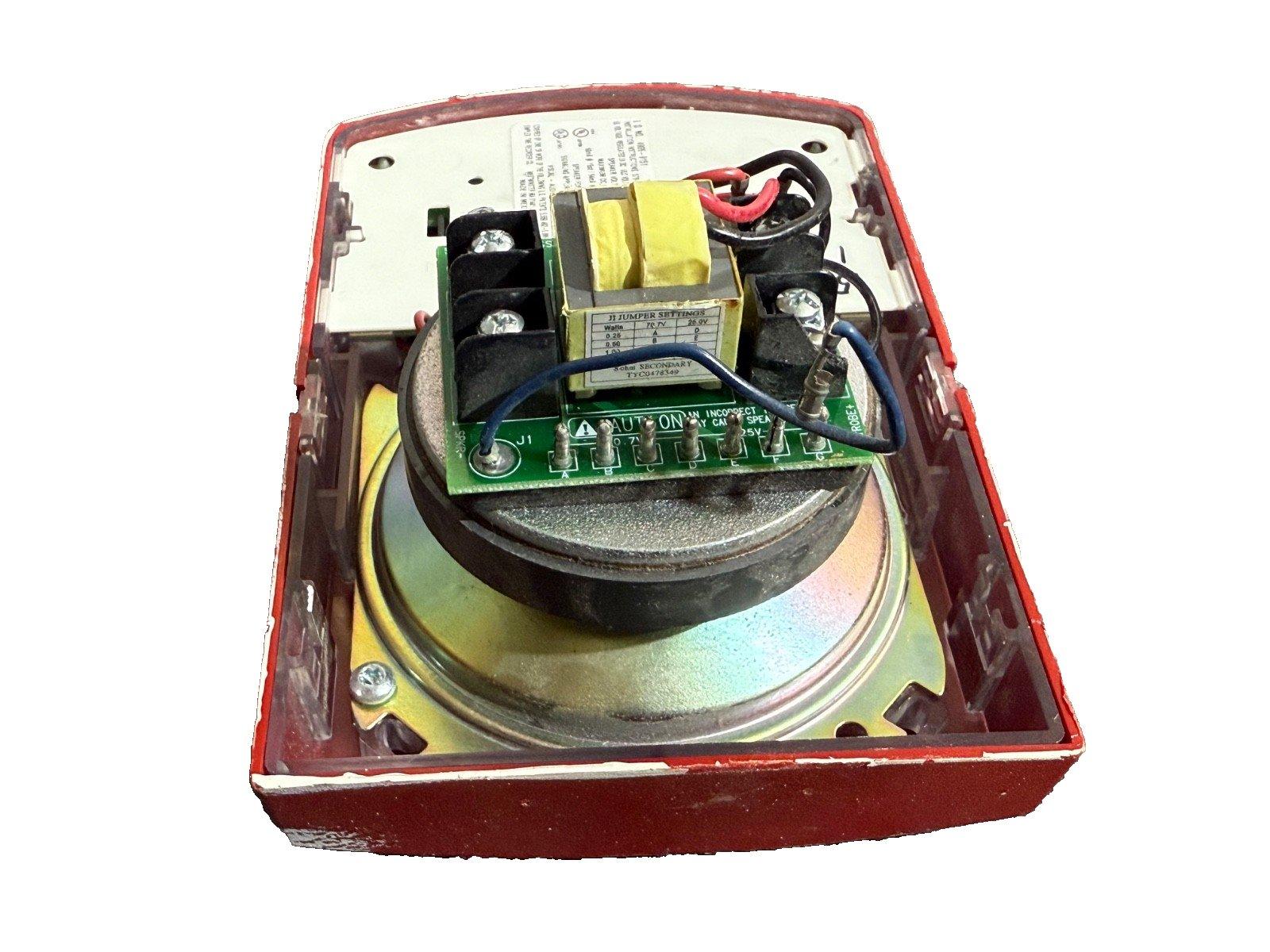 Used fire alarm horn with exposed circuit board, transformer, and wiring in red housing