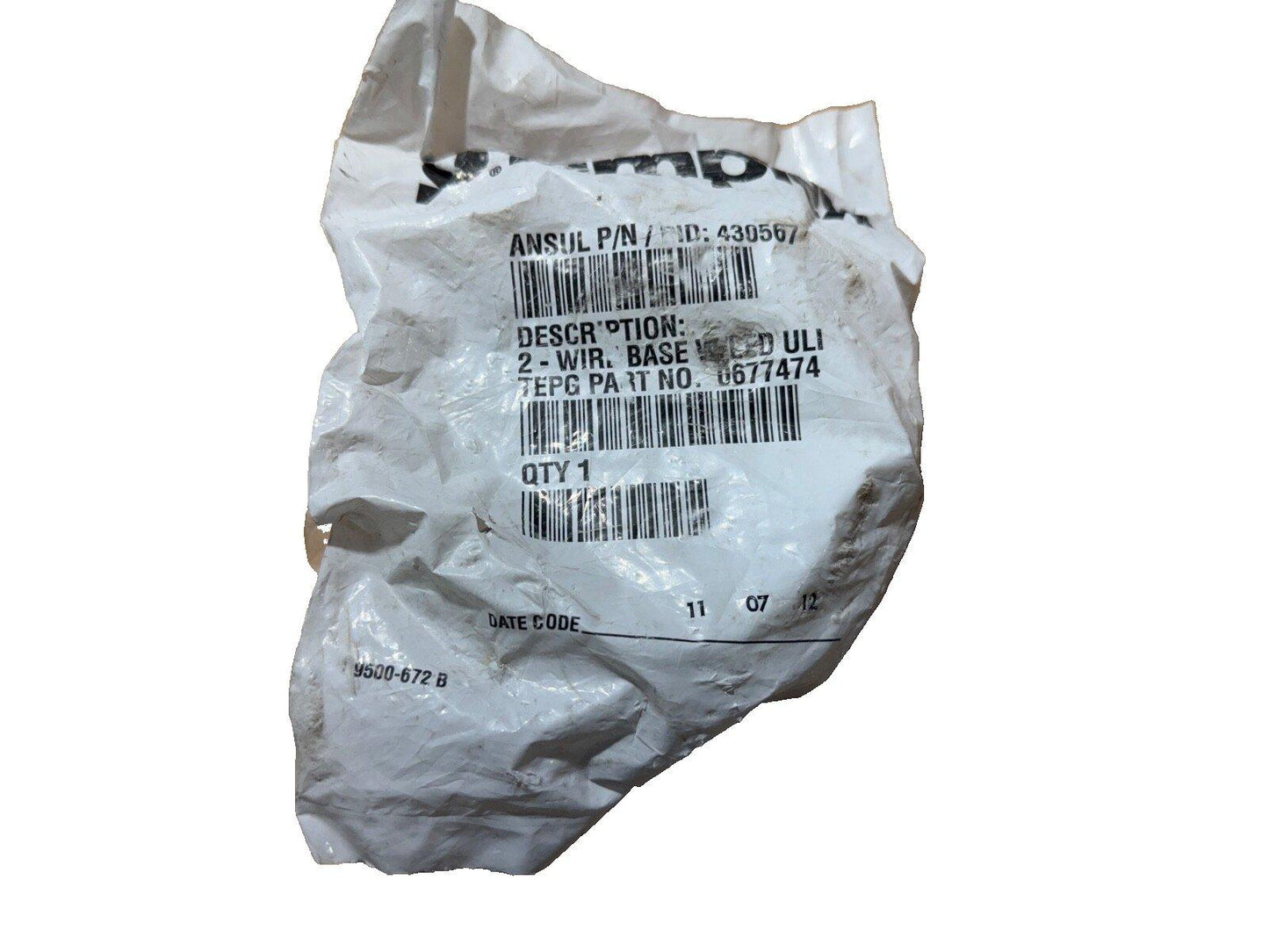 Crumpled plastic bag with fire alarm part label, 2-wire base, UL listed, part no. 0677474