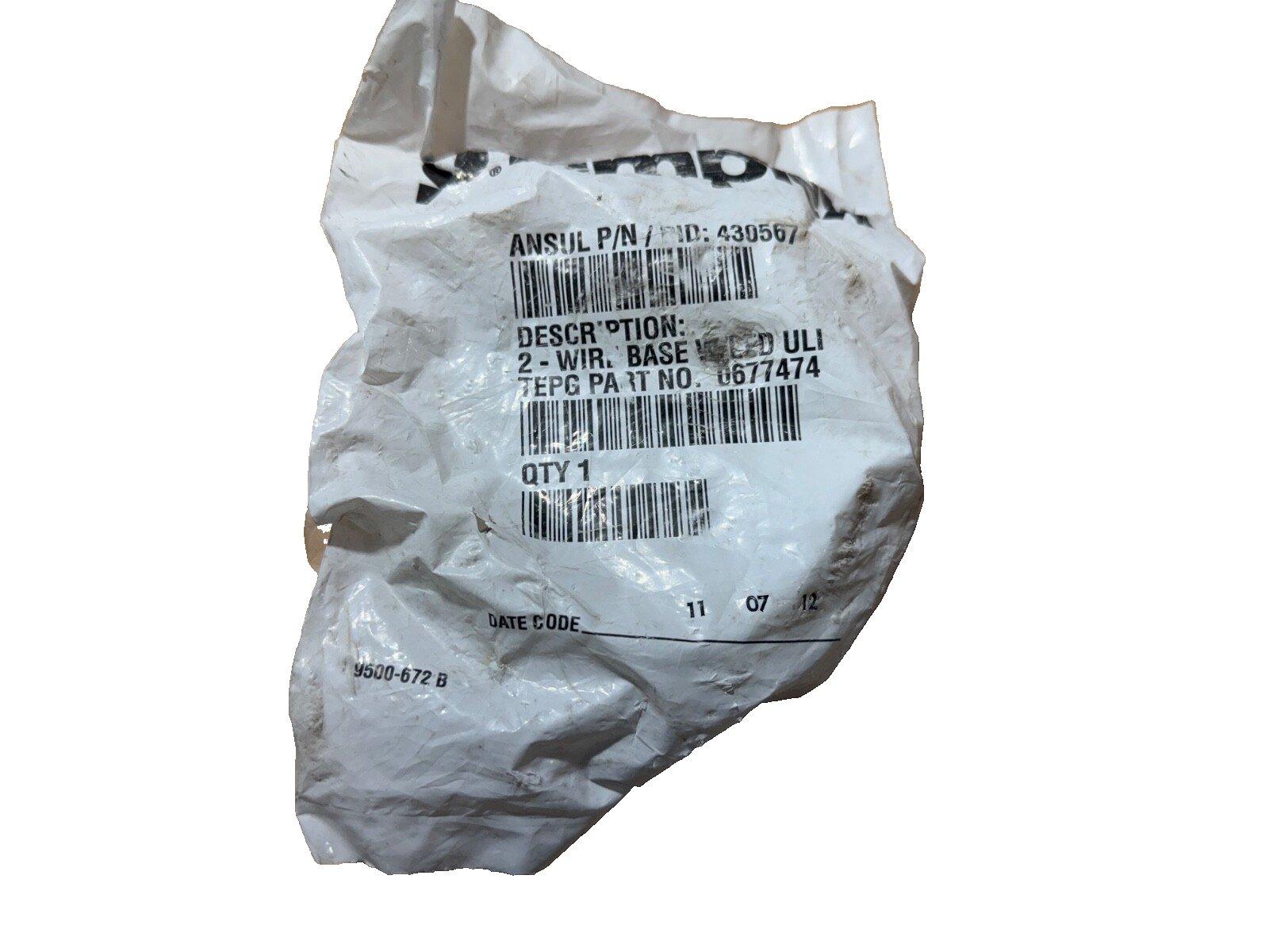 Crumpled plastic bag with fire alarm part label, 2-wire base, UL listed, part no. 0677474