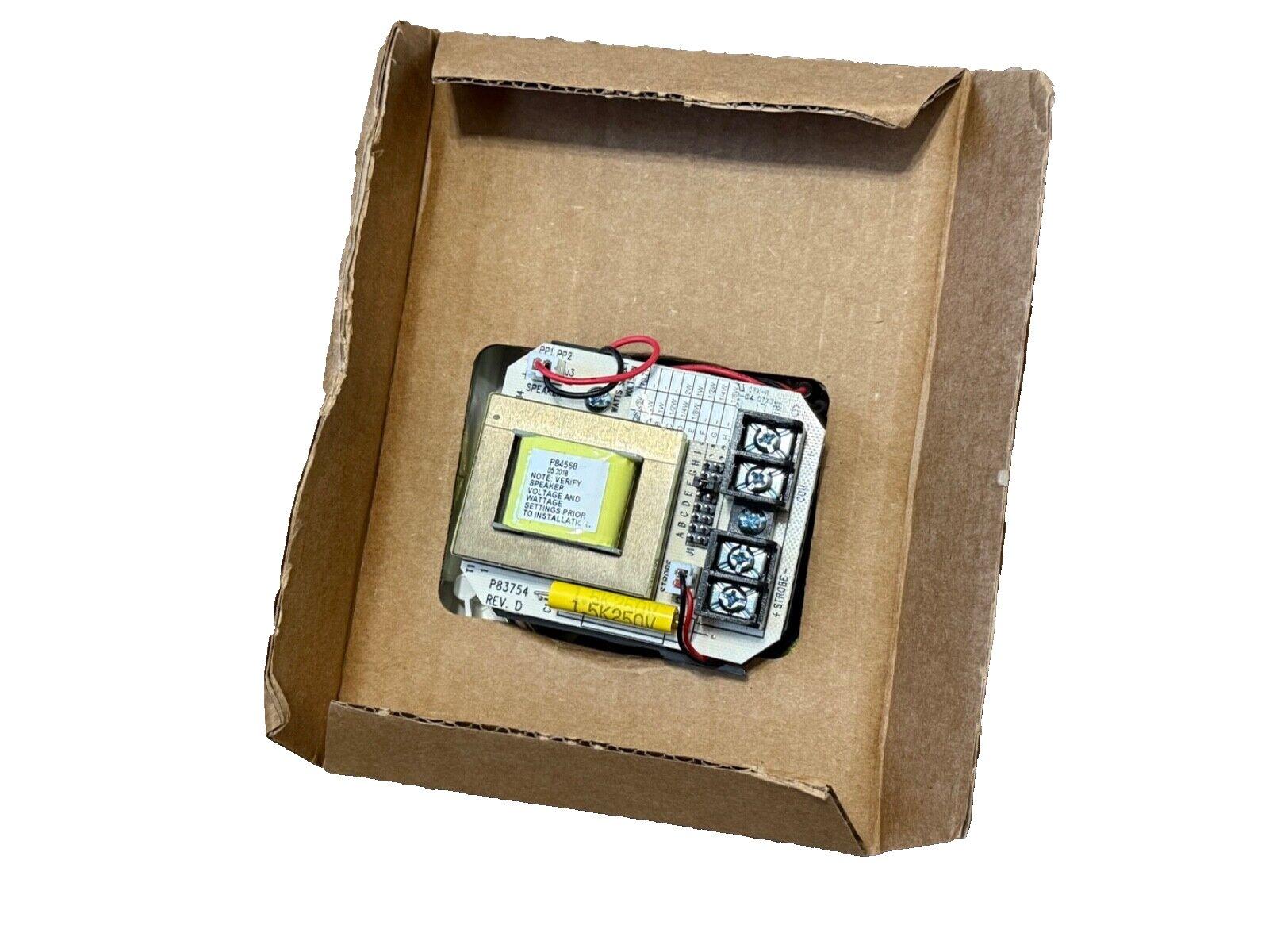 Fire alarm control module with wiring terminals and transformer in cardboard box