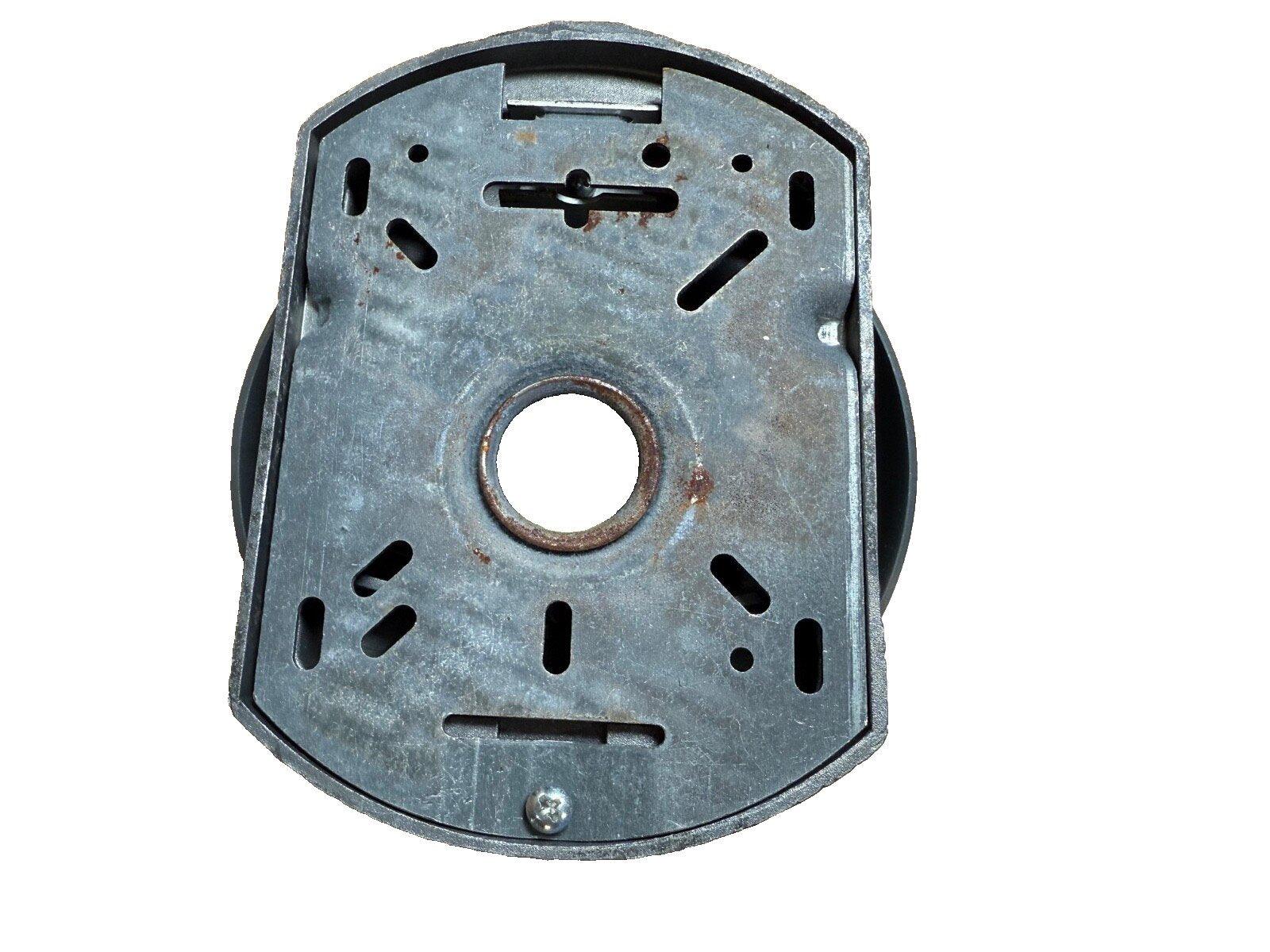 Metal fire alarm base with mounting slots and central hole, used fire safety equipment
