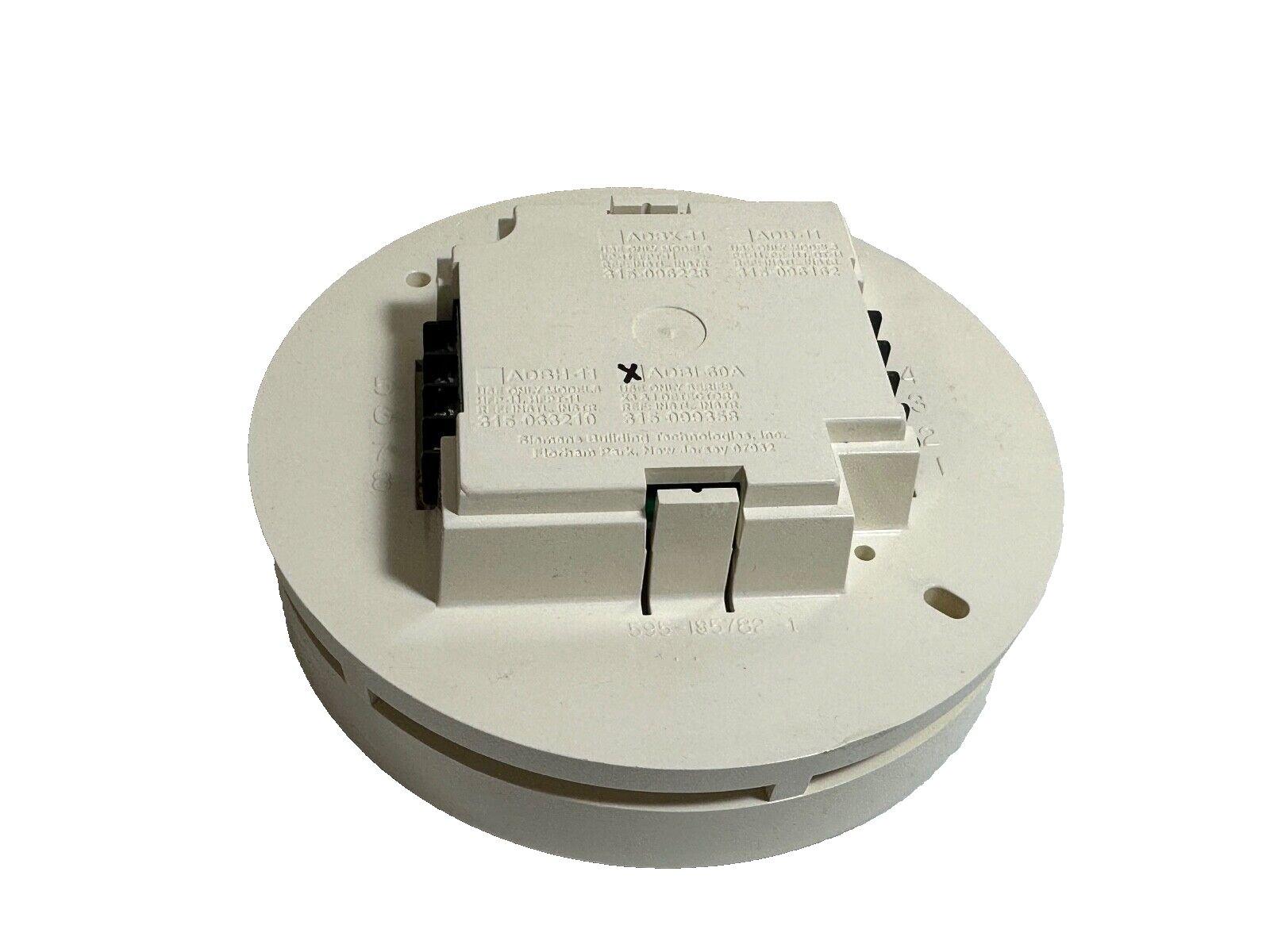 White fire alarm detector base with wiring terminals and model labels, compatible with fire safety systems