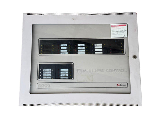 Simplex 4002 fire alarm control panel with zone indicators and warning label
