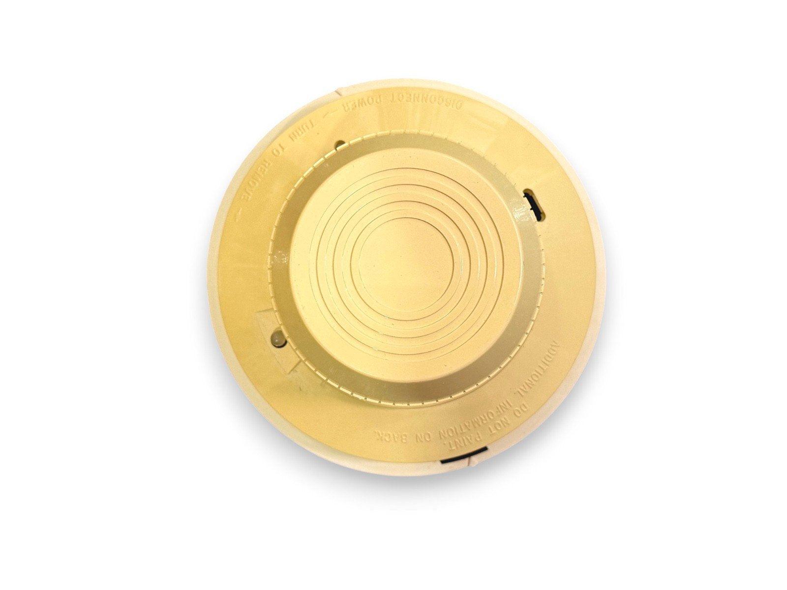 Yellow fire alarm detector base with mounting slots and power disconnect label