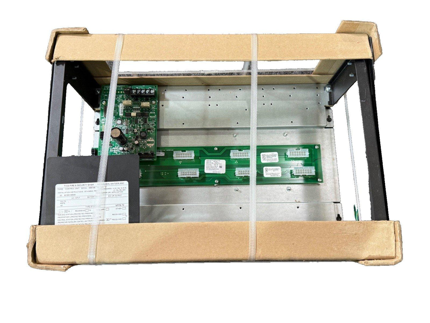 Fire alarm control panel with circuit boards, secured in shipping box for safe delivery