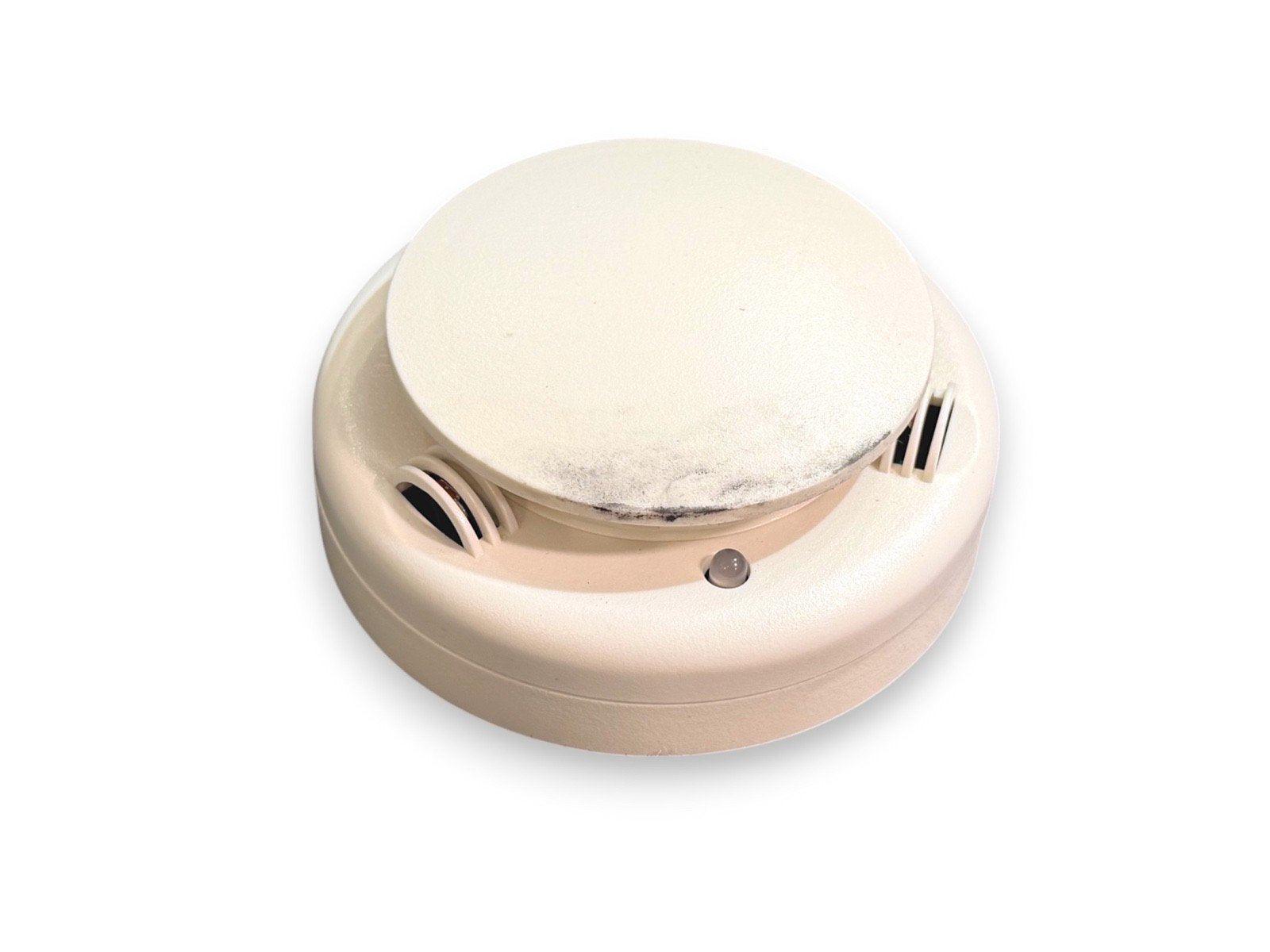 White smoke detector with vented sides and indicator light for fire alarm systems