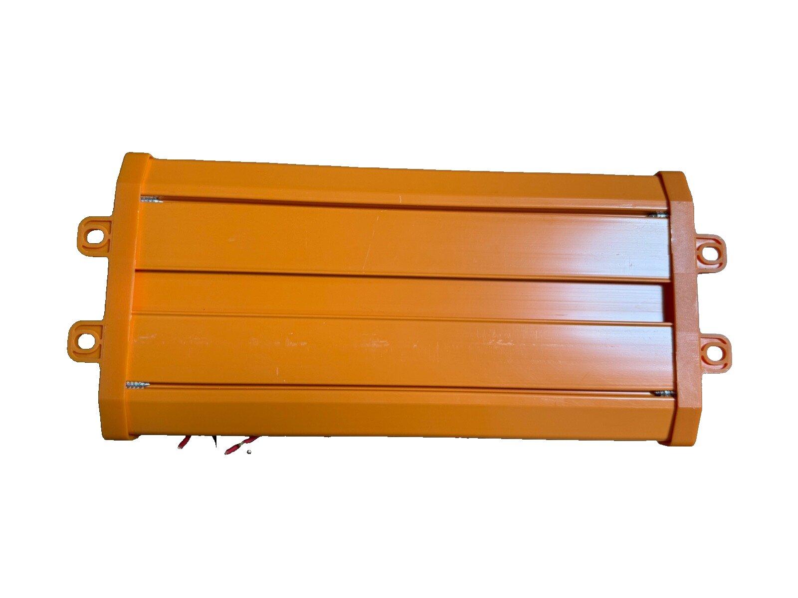 Orange fire alarm control panel with mounting brackets and wiring terminals