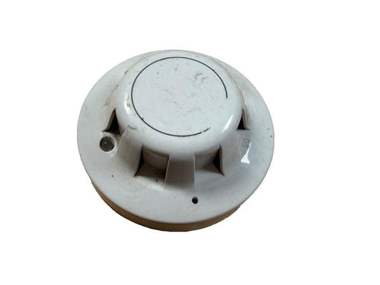Used white smoke detector with mounting base, fire alarm safety device