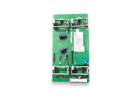 Green fire alarm control panel circuit board with UL labels and connector ports for security systems