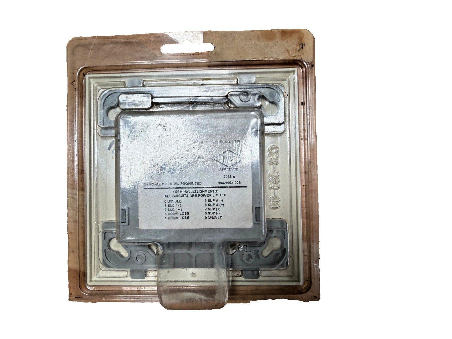 Fire alarm control module in sealed packaging, labeled with terminal assignments and UL approval