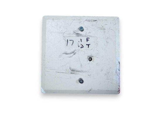 Used fire alarm pull station with handwritten label, showing wear and mounting screws