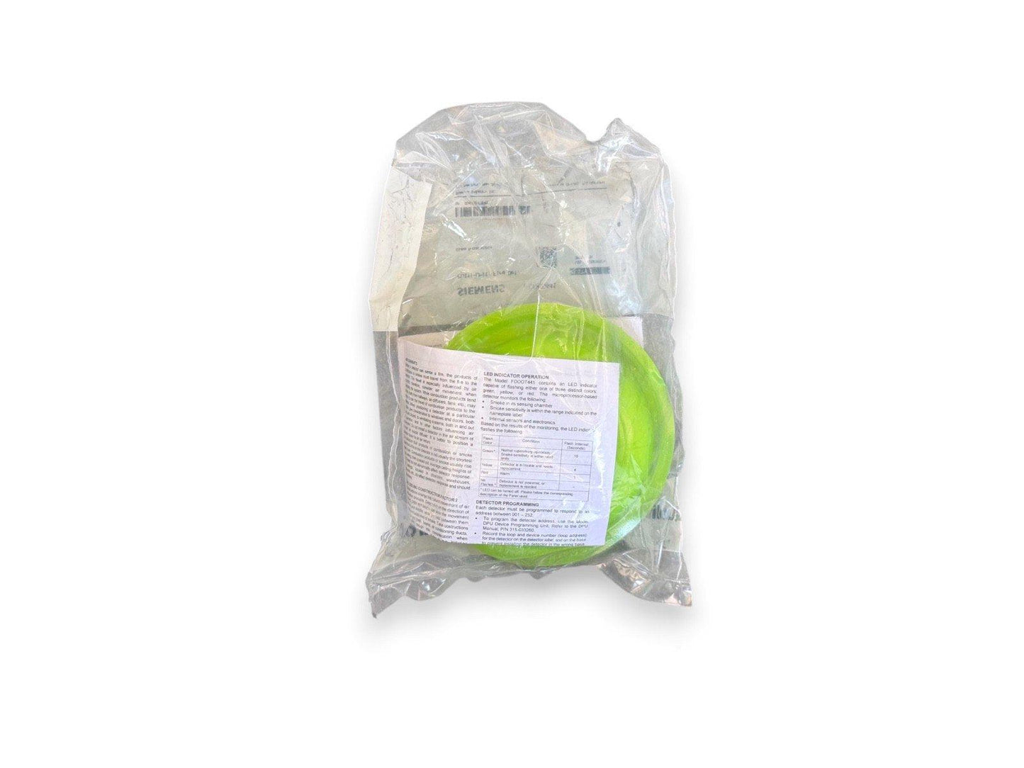 Green fire alarm detector in plastic packaging with instruction sheet, new surplus equipment