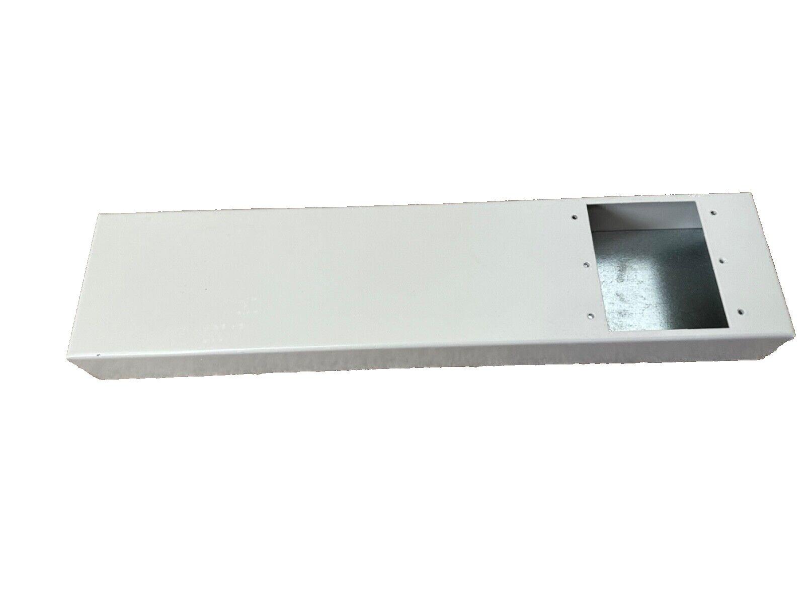 White fire alarm control panel enclosure with mounting holes and open compartment