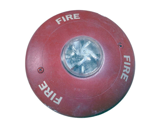 Red fire alarm strobe light with 'FIRE' text, used fire safety equipment