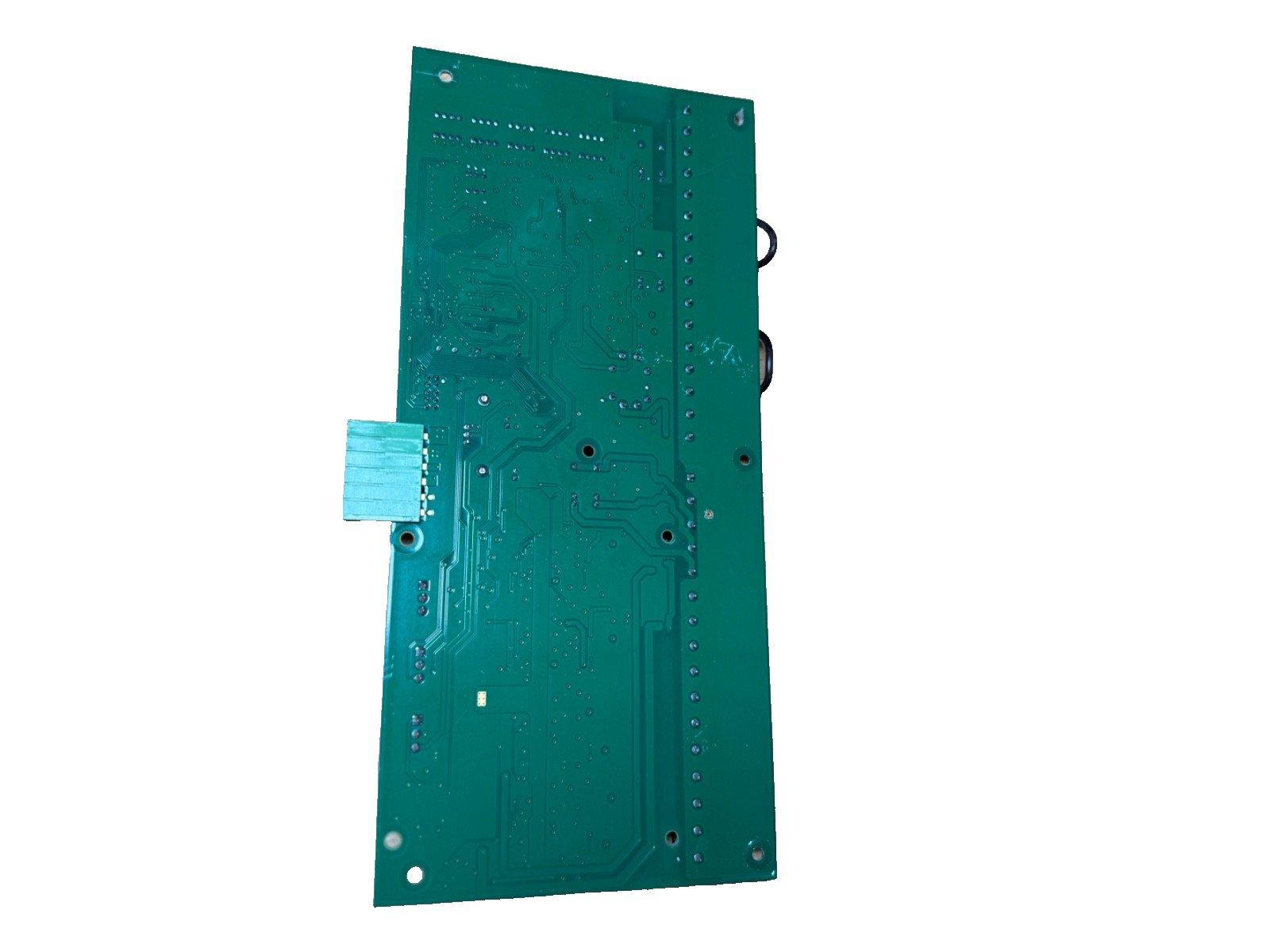 Green fire alarm control panel circuit board with connectors and mounting holes
